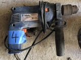 a drill that is sitting on the floor next to a cord