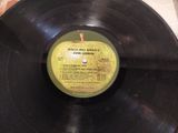 a black record with a yellow label sitting on a table