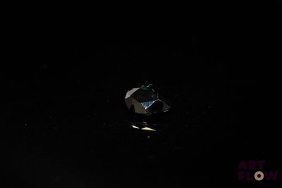 a broken apple sitting on a table in the dark