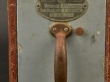 a small metal box with a handle on it