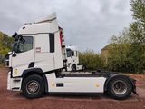 a white semi truck parked in a parking lot