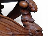 a close up of a wooden table with a bird on it