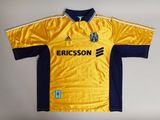 the shirt is yellow and blue with a white stripe on it