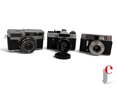 three cameras sitting next to each other on a white surface