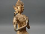 an image of a statue of a person kneeling on a gray surface