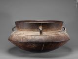 an old wooden bowl sitting on top of a table