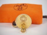 an orange pouch with a gold buckle on it and an orange bag with a gold clasp