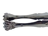 a silver spoon with a lion head on it