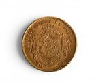 a close up of a coin on a white surface