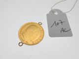 a close up of a gold coin with a price tag on it
