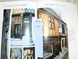 an open book with a picture of a building in it