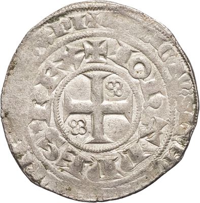 une vieille pièce d'argent ornée d'une croix