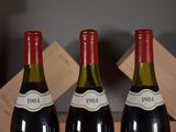 three bottles of wine that are sitting on a table