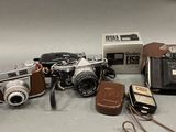 many different types of cameras on the table