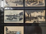 many pictures of boats on display on the wall
