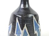 a black vase with blue and white designs on it