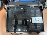 a suitcase with tools inside of it on the floor