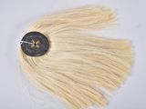 a hair piece with a button on it on a white surface