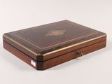 a small wooden box with a lid on a white surface