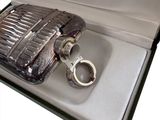 a lighter in a box with a pair of handcuffs in it