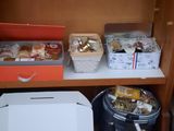 many baskets of food on a shelf in a store