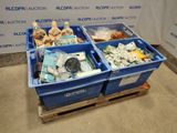 deux bacs bleus remplis d'objets divers, posés sur une palette