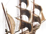a wooden model of a ship on a white surface