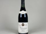 une bouteille de vin posée sur une table blanche