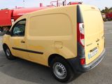 a yellow van that is parked in a parking lot