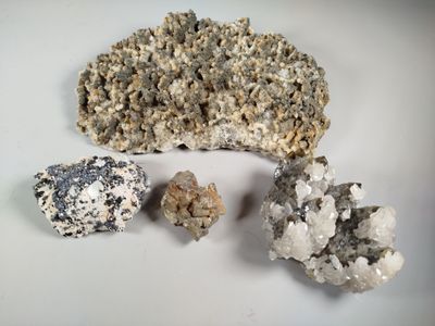 three different types of rocks on a white surface