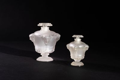 pair of white glass vases sitting on a black surface