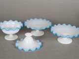 four white and blue glass dishes and cups on a gray surface