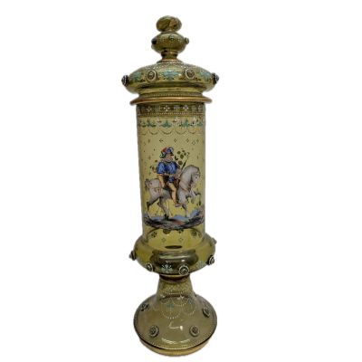 a gold vase with a picture of a man riding a horse on it