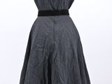 a dress on a mannequin stand on a white background