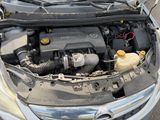 the engine of a car with its hood open on the street