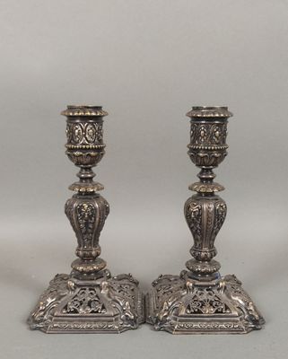 pair of antique silver candlesticks with floral designs