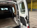 a white van with its doors open in a parking lot