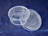 two clear plastic containers sitting on top of a blue cloth
