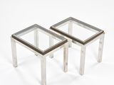 pair of chrome and glass side tables on a white background