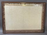 an old picture frame with a piece of paper taped around it