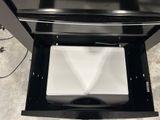 a black oven with a white microwave inside of it