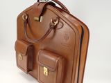 brown leather briefcase with two pockets and a handle