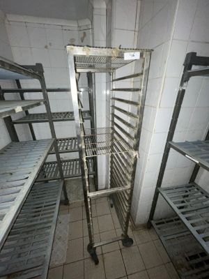 a metal rack in the middle of a room filled with shelves