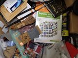 a pile of books and other items on a bed