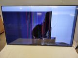 the television is sitting on the bed in the corner of the room