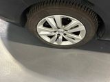 a reflection of a man standing on the side of a car
