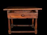 an old wooden table with a drawer underneath it on a black background
