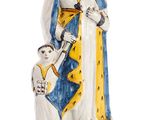 a statue of a woman holding a baby and a dog