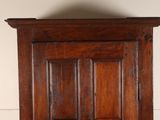 a wooden cabinet with a clock on top of it