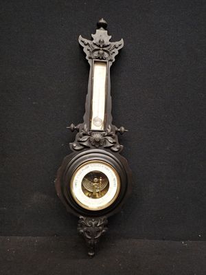 a clock hanging on the wall with a black background